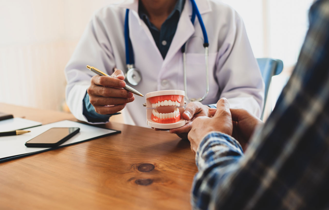 dentist-demonstrating-how-the-bite-works-with-a-fake-jaw